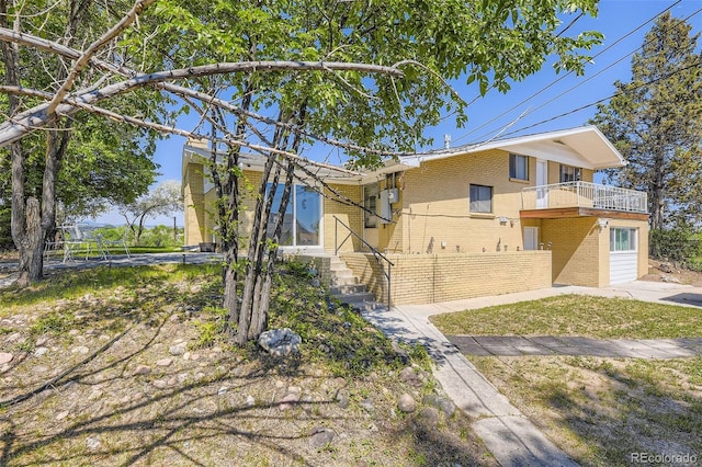 34 S Raleigh St, Denver, CO 80219 - view of front facade with brick siding and a balcony