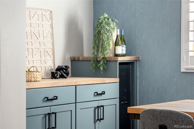 interior space featuring wallpapered walls and wine cooler