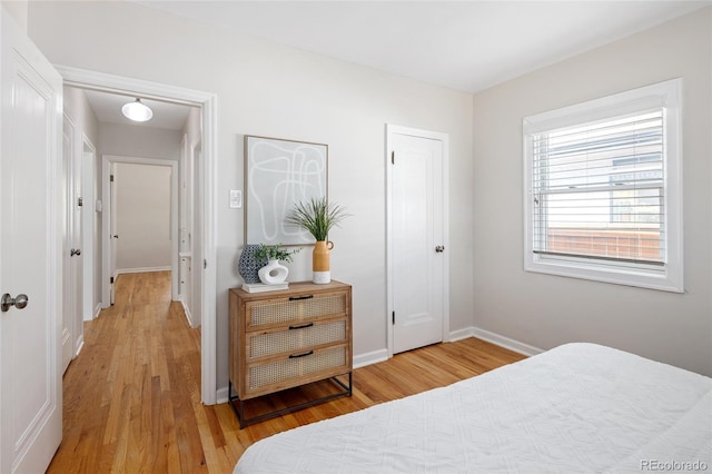 bedroom with baseboards and light wood-type flooring