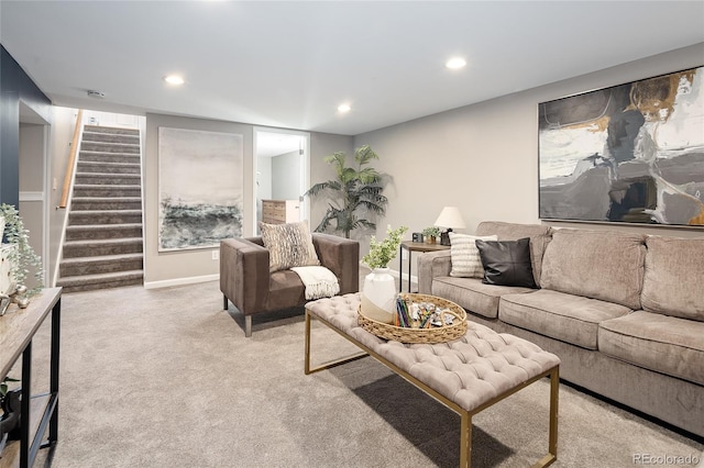 carpeted living area featuring baseboards, stairs, and recessed lighting