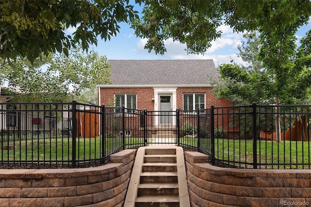 view of gate featuring a fenced front yard and a lawn