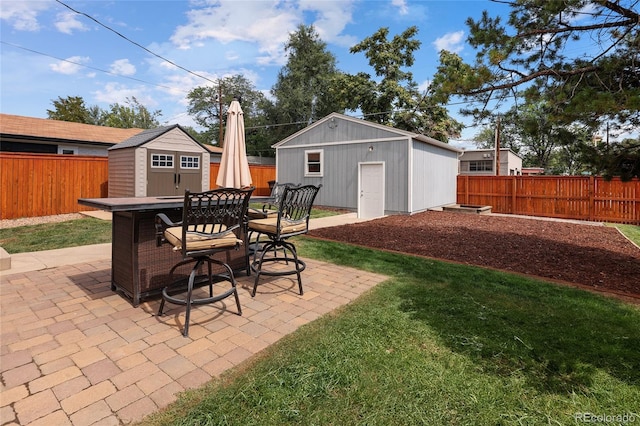 view of patio featuring a fenced backyard and an outbuilding