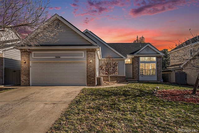 ranch-style house featuring a lawn and a garage