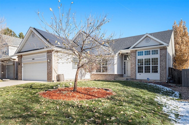 view of front of home with a front yard and a garage