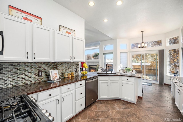 kitchen featuring white cabinetry, sink, stainless steel appliances, kitchen peninsula, and pendant lighting