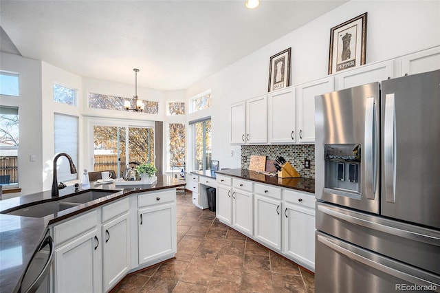 kitchen featuring a wealth of natural light, sink, white cabinets, and stainless steel appliances