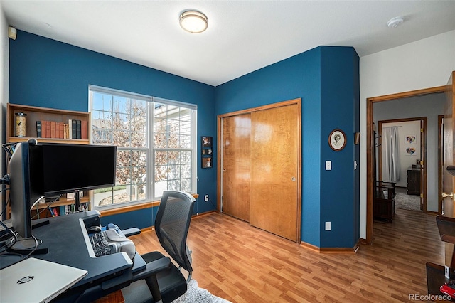 home office with hardwood / wood-style flooring