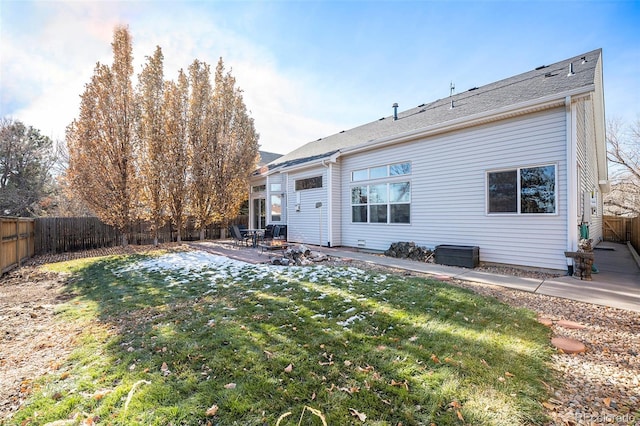 back of house featuring a yard and a patio