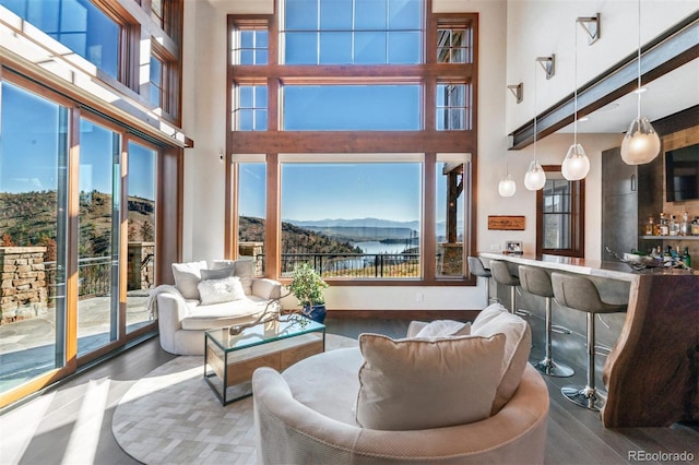 5188 Csh 125, Granby, CO 80446 - living room with wood finished floors, a towering ceiling, and a mountain view