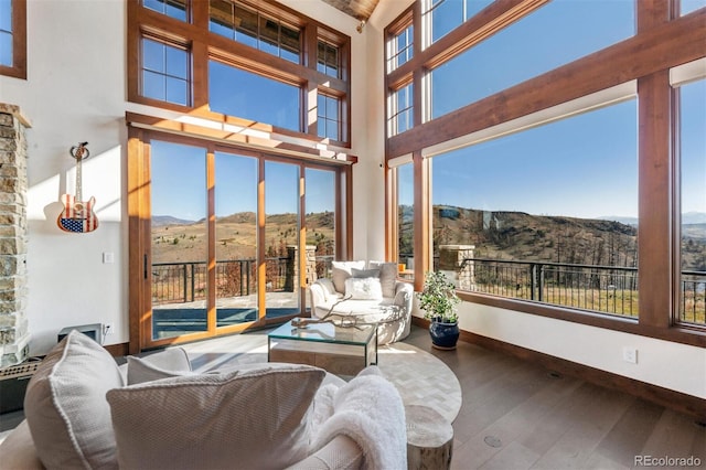 sunroom with a wealth of natural light and a mountain view