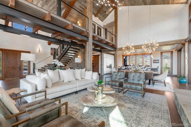 5188 Csh 125, Granby, CO 80446 - living area with high vaulted ceiling, a chandelier, wood finished floors, stairway, and wood ceiling with exposed beams