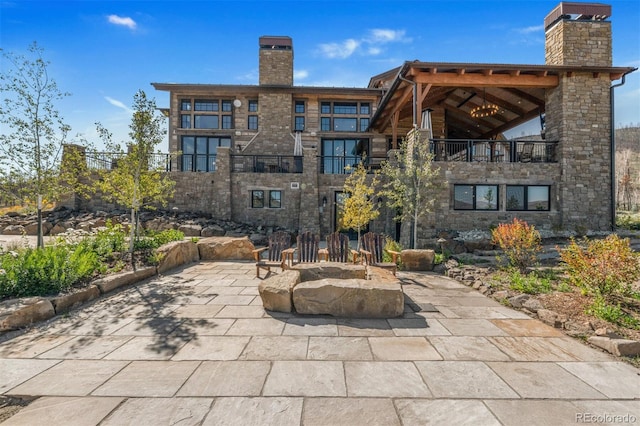 5188 Csh 125, Granby, CO 80446 - view of patio featuring a balcony and an outdoor fire pit