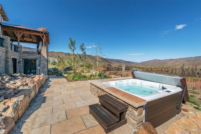 5188 Csh 125, Granby, CO 80446 - view of swimming pool with a hot tub, a mountain view, and a patio area