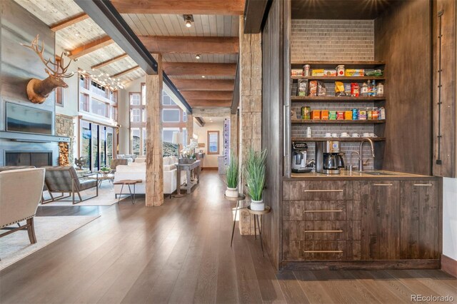 5188 Csh 125, Granby, CO 80446 - indoor bar with a fireplace, wooden ceiling with exposed beams, wood-type flooring, and high vaulted ceiling