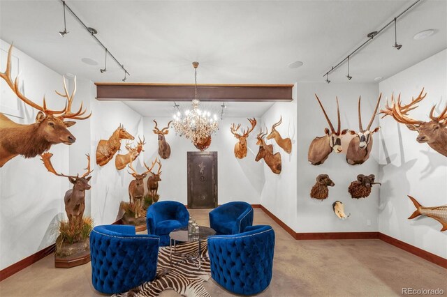 5188 Csh 125, Granby, CO 80446 - living area featuring track lighting, a chandelier, baseboards, and concrete floors
