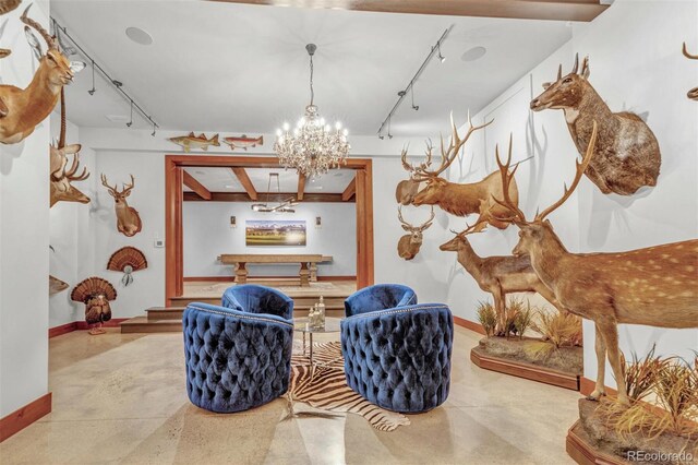 5188 Csh 125, Granby, CO 80446 - sitting room featuring track lighting, a chandelier, baseboards, and concrete floors
