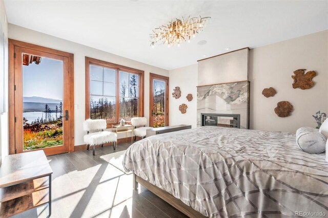 5188 Csh 125, Granby, CO 80446 - bedroom featuring wood finished floors, access to outside, and a glass covered fireplace