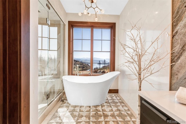 5188 Csh 125, Granby, CO 80446 - bathroom with a mountain view, a soaking tub, plenty of natural light, and a chandelier