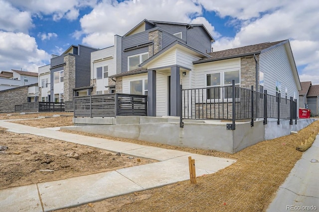 2404 W 69th Pl, Denver, CO 80221 - view of front of home with stone siding and a residential view