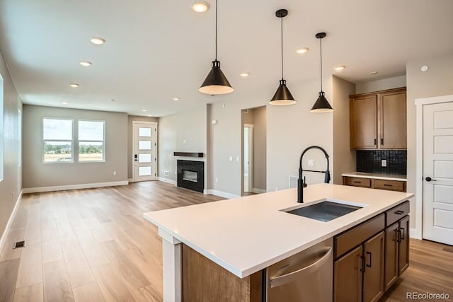 2404 W 69th Pl, Denver, CO 80221 - kitchen featuring dishwasher, open floor plan, light wood-type flooring, light countertops, and recessed lighting