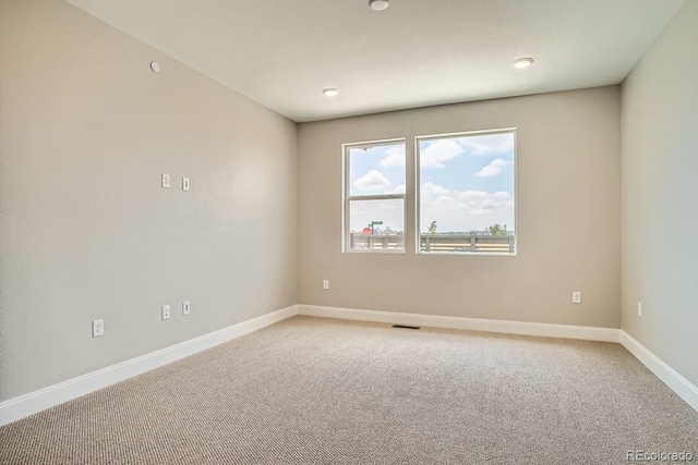 2404 W 69th Pl, Denver, CO 80221 - spare room featuring light colored carpet and recessed lighting