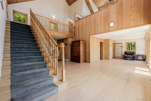 3581 Gap Rd, Golden, CO 80403 - stairs with high vaulted ceiling, wood walls, wood finished floors, and beamed ceiling