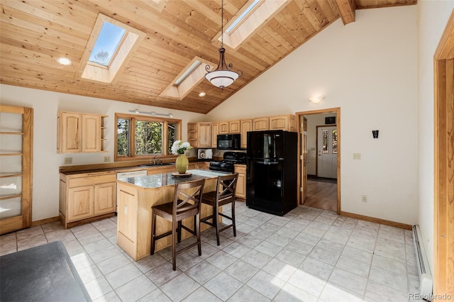3581 Gap Rd, Golden, CO 80403 - kitchen with light brown cabinetry, black appliances, a skylight, baseboard heating, and a sink