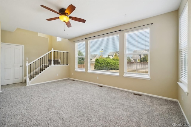 unfurnished room with carpet and ceiling fan