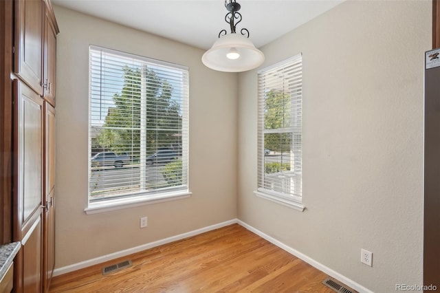 spare room featuring light wood-type flooring