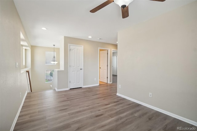 unfurnished room with ceiling fan and hardwood / wood-style floors