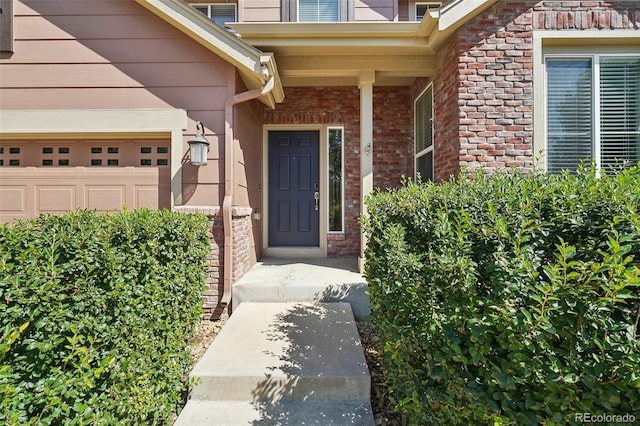 doorway to property with a garage