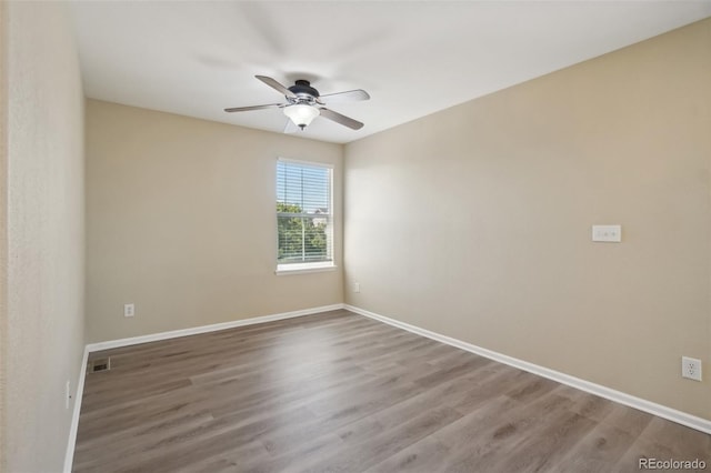 unfurnished room featuring hardwood / wood-style floors and ceiling fan