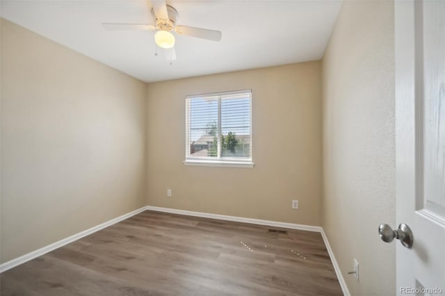 empty room with wood-type flooring and ceiling fan