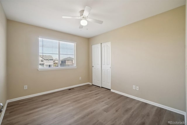 empty room with ceiling fan and light hardwood / wood-style flooring