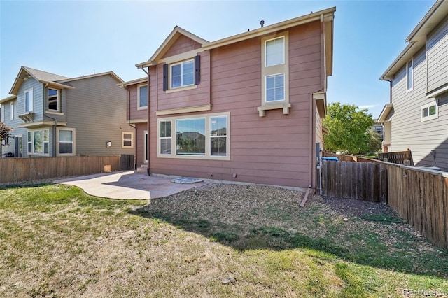 back of property featuring a patio area and a yard