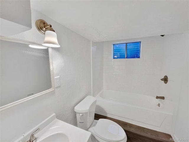 full bathroom with tiled shower / bath combo, vanity, and toilet