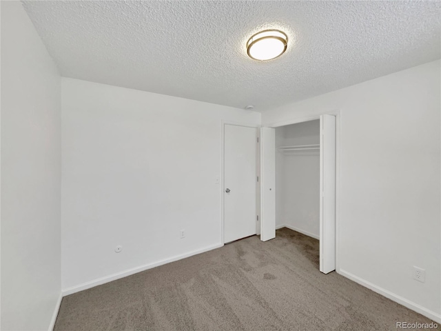 unfurnished bedroom featuring carpet, a closet, and a textured ceiling