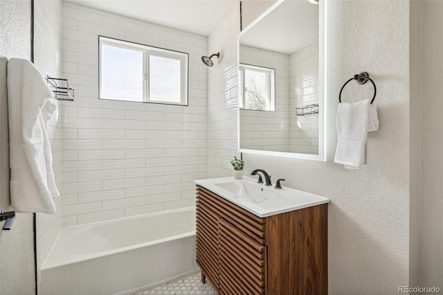 bathroom with vanity and tiled shower / bath