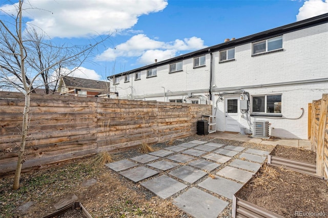 rear view of property with cooling unit and a patio area