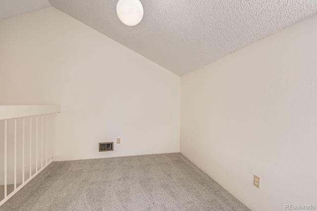 3558 S Depew St Unit 302, Denver, CO 80235 - unfurnished room featuring vaulted ceiling, carpet, and a textured ceiling