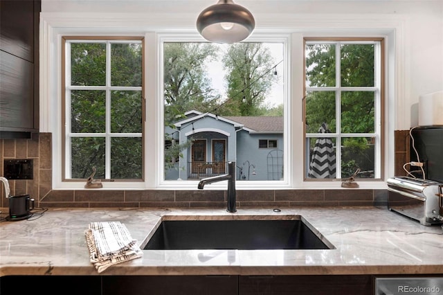 1502 Columbine Ave, Boulder, CO 80302 - kitchen featuring a sink, light stone countertops, tasteful backsplash, dishwasher, and healthy amount of natural light