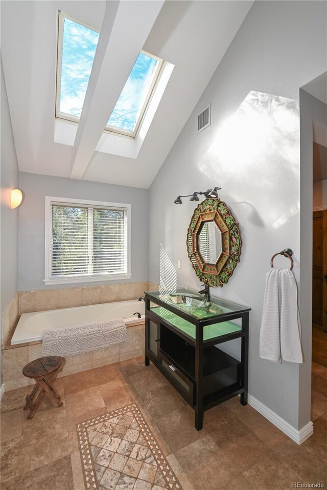 1502 Columbine Ave, Boulder, CO 80302 - bathroom with lofted ceiling, a skylight, a bath, and vanity