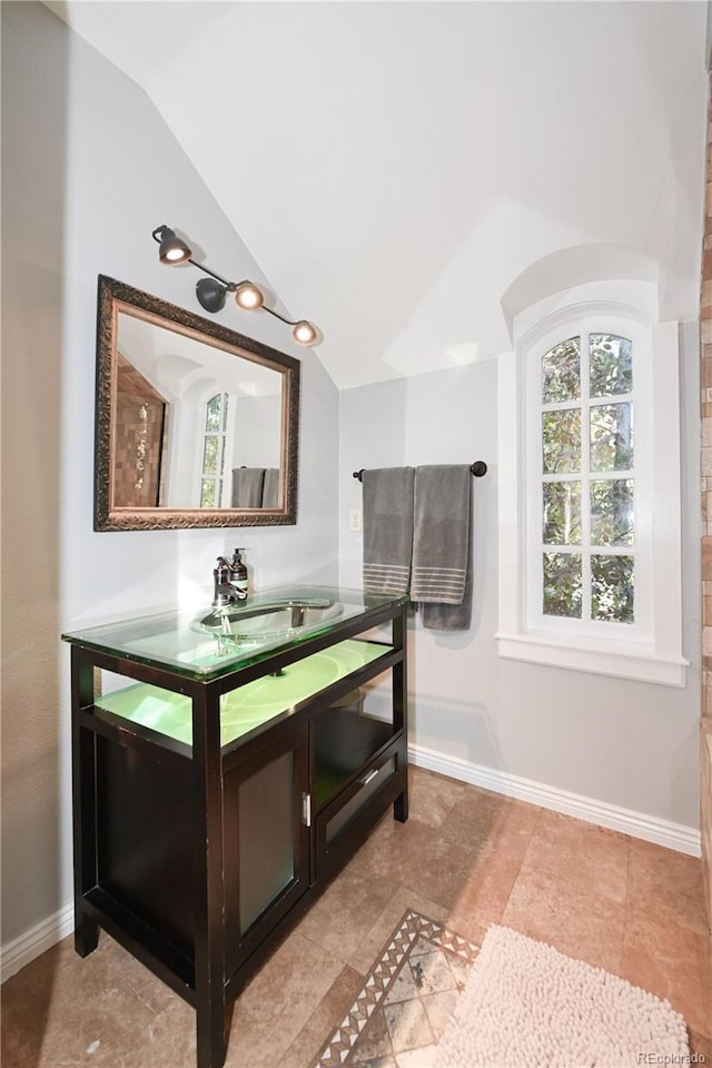 1502 Columbine Ave, Boulder, CO 80302 - bathroom featuring vanity, lofted ceiling, and baseboards