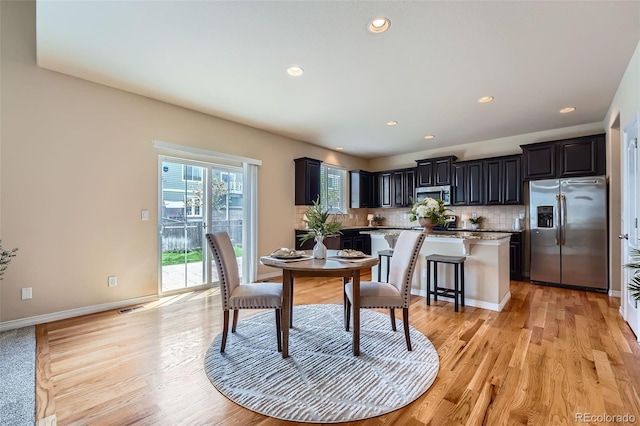 dining room with recessed lighting, light wood-style floors, baseboards, and visible vents