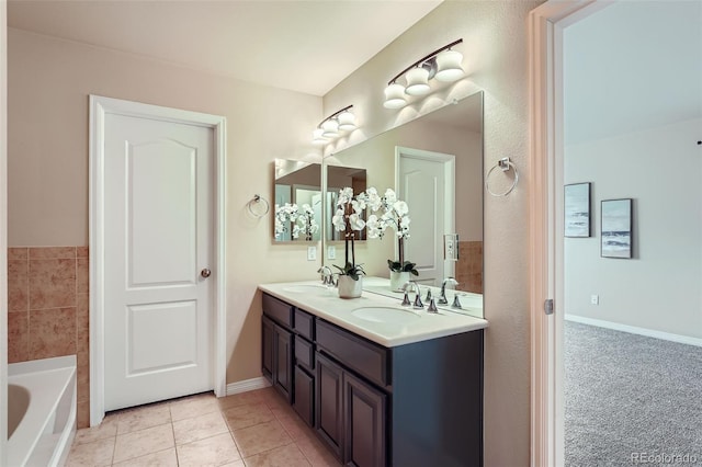 full bath with tile patterned flooring, a sink, double vanity, and a washtub