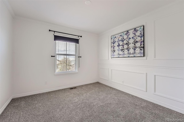 carpeted spare room with crown molding, baseboards, and visible vents