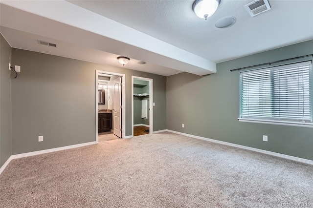 unfurnished bedroom with baseboards, visible vents, and light carpet