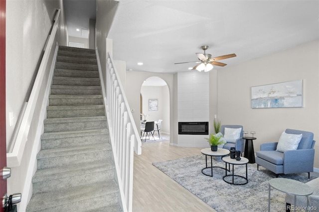 10693 W 63rd Dr Unit 106, Arvada, CO 80004 - stairs with arched walkways, wood finished floors, ceiling fan, recessed lighting, and a fireplace