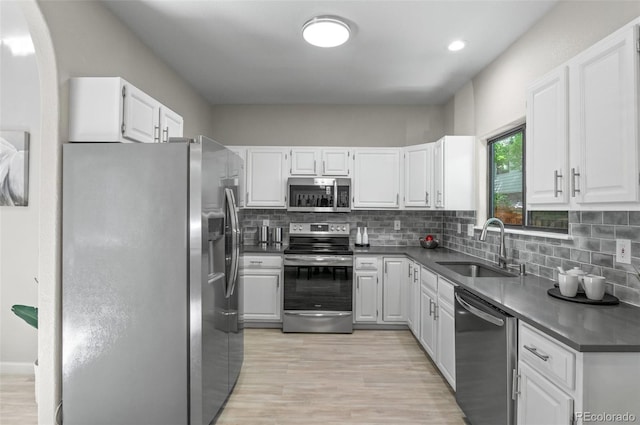10693 W 63rd Dr Unit 106, Arvada, CO 80004 - kitchen featuring appliances with stainless steel finishes, white cabinetry, and decorative backsplash