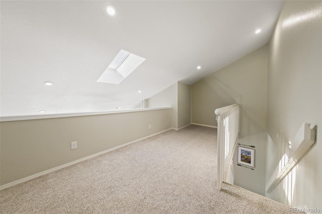 bonus room featuring light colored carpet and vaulted ceiling with skylight